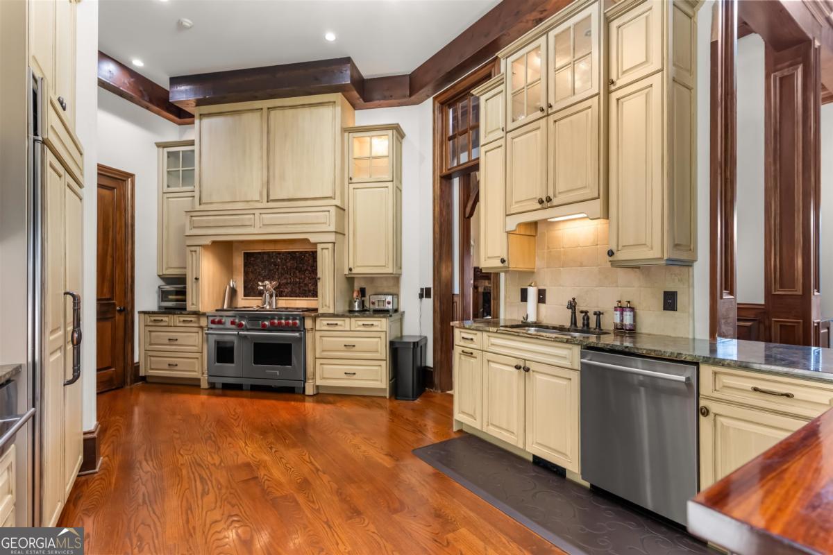 1090 Spring Creek Greensboro, GA 30642 - Photo 29 of 75 a kitchen with stainless steel appliances a stove sink and refrigerator