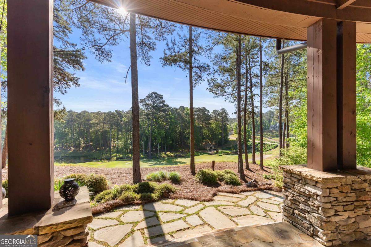 1090 Spring Creek Greensboro, GA 30642 - Photo 35 of 75 a view of a balcony with chair and floor to ceiling window
