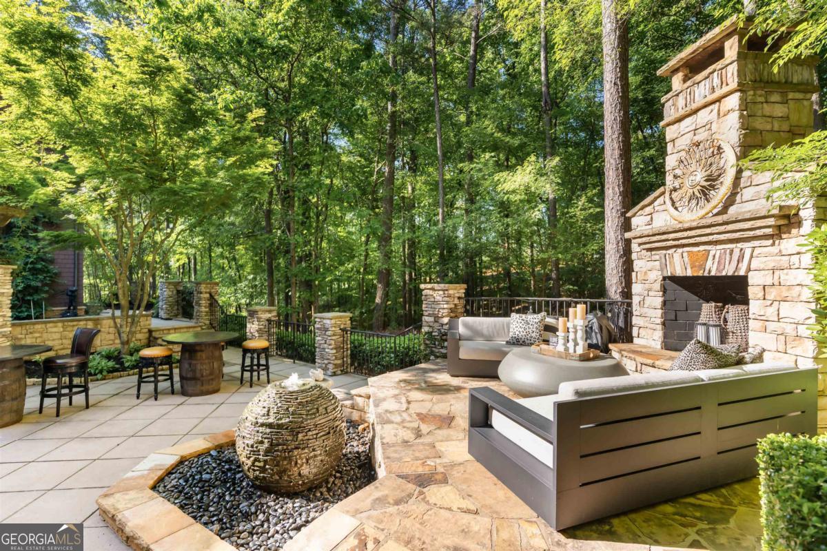 1090 Spring Creek Greensboro, GA 30642 - Photo 44 of 75 a view of a patio with couches table and chairs and potted plants