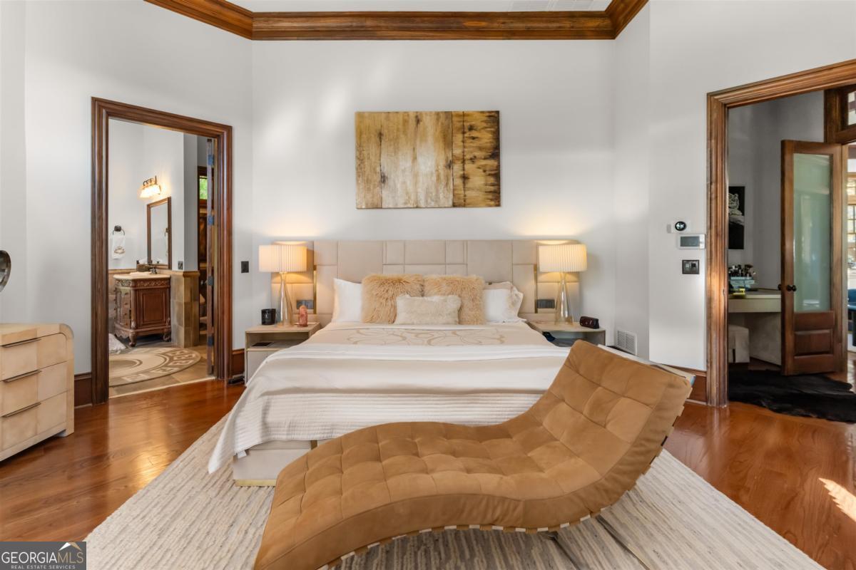 1090 Spring Creek Greensboro, GA 30642 - Photo 47 of 75 a spacious bedroom with a bed and wooden floor