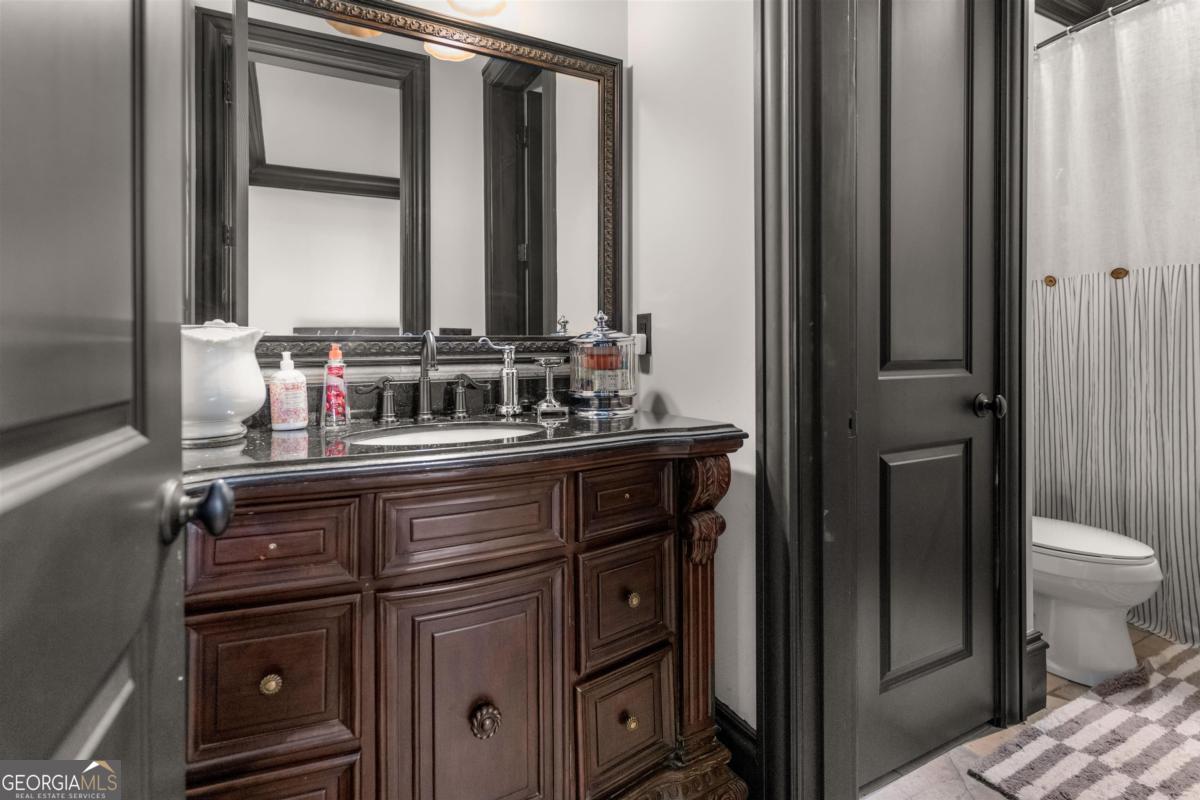 1090 Spring Creek Greensboro, GA 30642 - Photo 64 of 75 a bathroom with a sink and a mirror