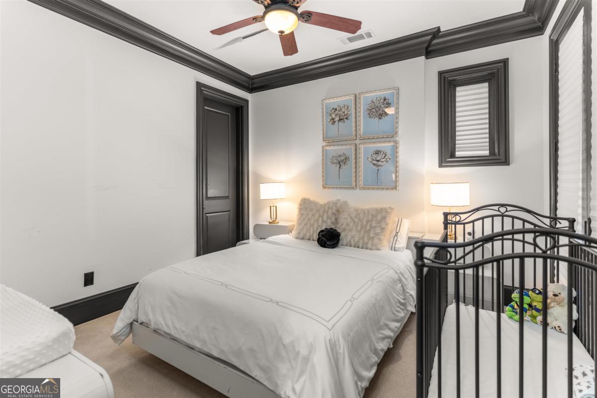 1090 Spring Creek Greensboro, GA 30642 - Photo 65 of 75 a bedroom with a bed and a chandelier