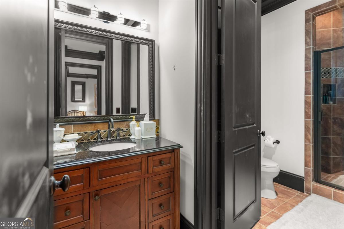 1090 Spring Creek Greensboro, GA 30642 - Photo 66 of 75 a bathroom with a sink and a mirror