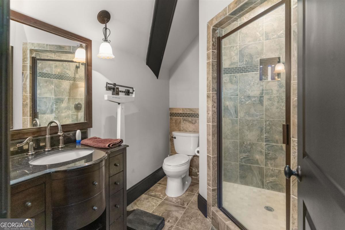 1090 Spring Creek Greensboro, GA 30642 - Photo 73 of 75 a bathroom with a sink a toilet and a mirror