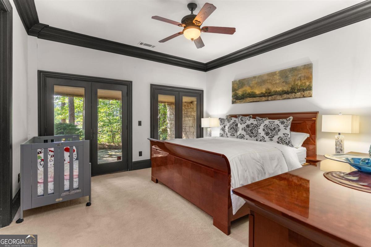 1090 Spring Creek Greensboro, GA 30642 - Photo 74 of 75 a bedroom with a bed and a chandelier