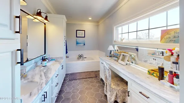 a bathroom with a tub sink and a window