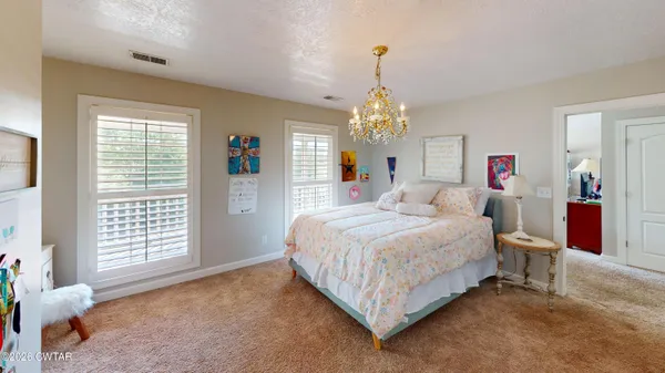 a bedroom with bed and window