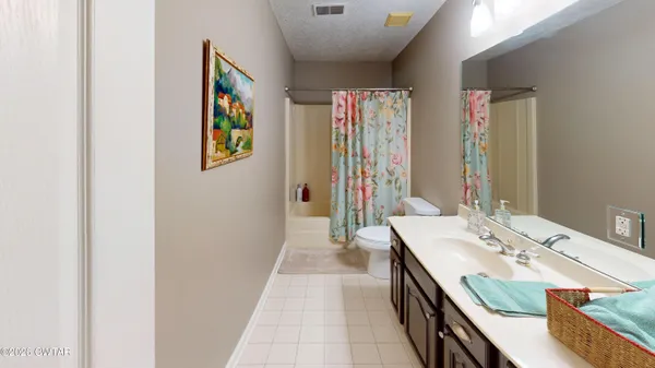 a en suite bathroom with a double vanity sink and a mirror