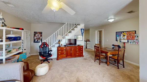a living room with furniture and a baby crib