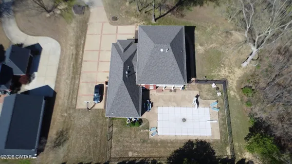 an aerial view of a house with outdoor space and a lake view