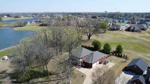 an aerial view of a house with a lake view