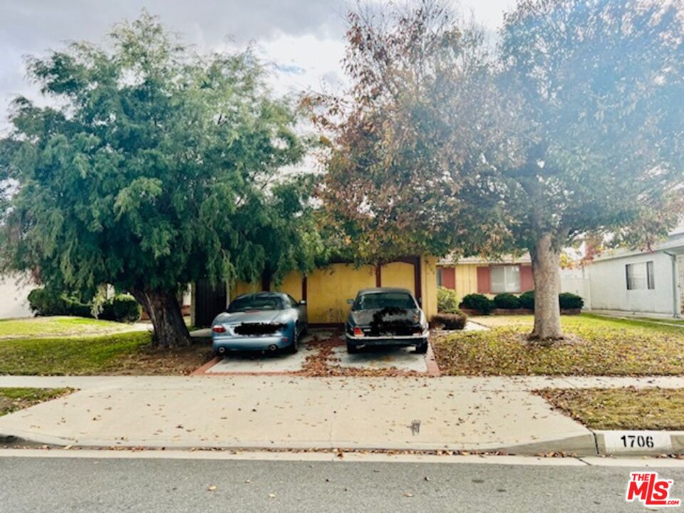 1706 East Edom Street Carson, CA 90746 - Photo 1 of 6 a car parked in front of white house