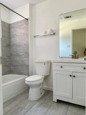 a bathroom with a sink a toilet and a bathtub