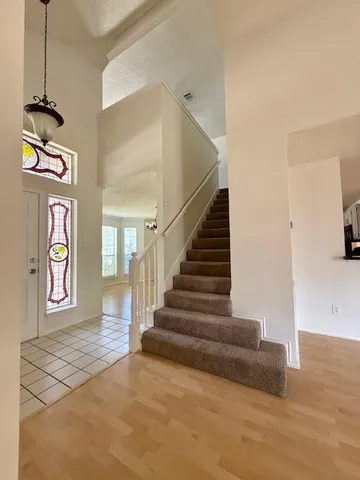 a view of entryway and hall with wooden floor