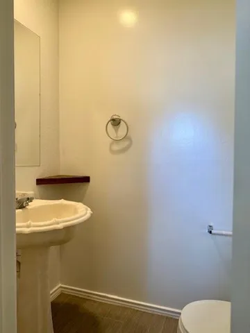 a bathroom with a sink a toilet and a mirror
