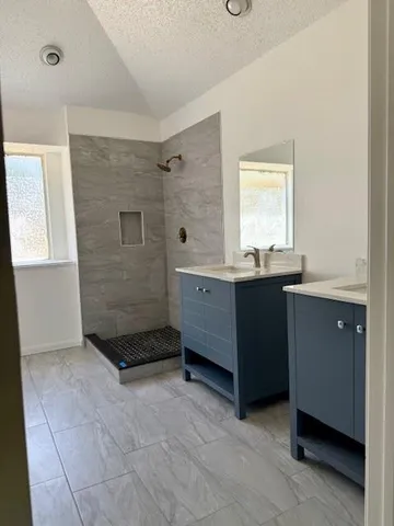 a spacious bathroom with a bathtub and a sink