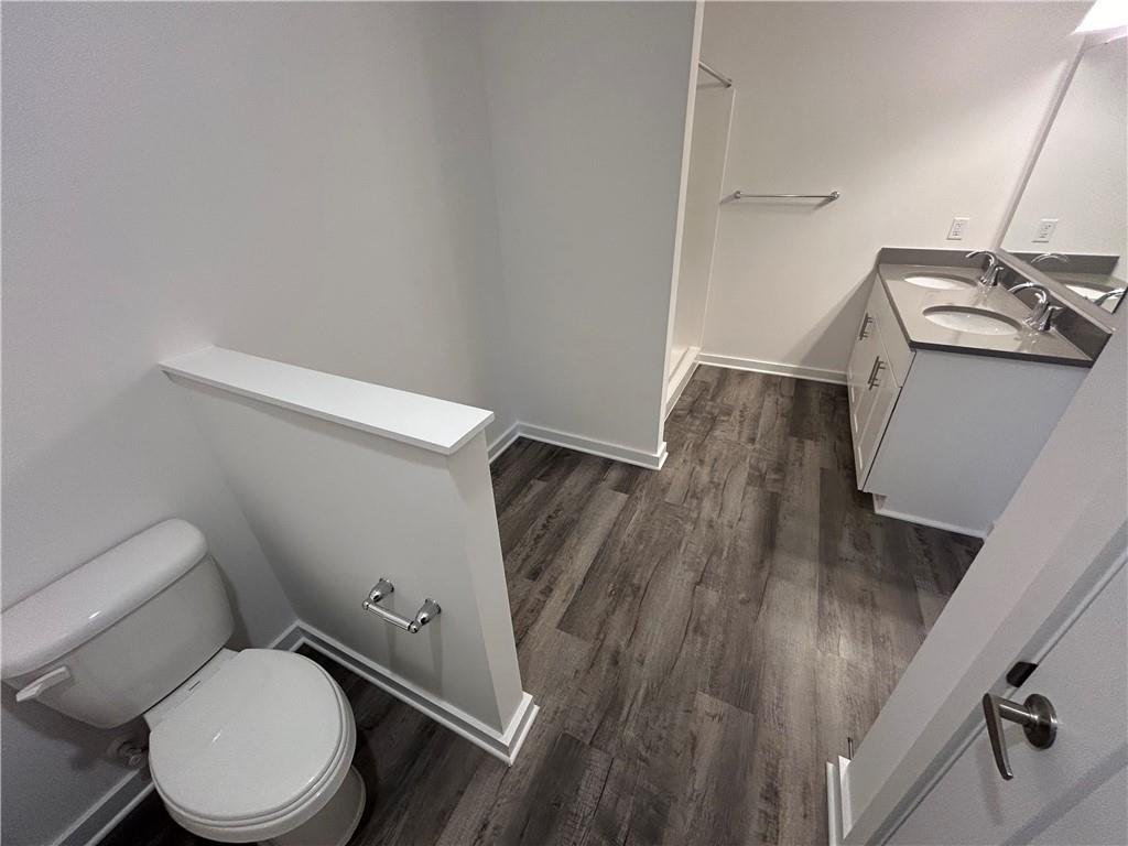 203 Lola Court McKees Rocks, PA 15136 - Photo 21 of 23 a white toilet sitting next to a wooden floor
