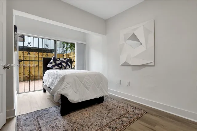 a bed sitting in a bedroom next to a window