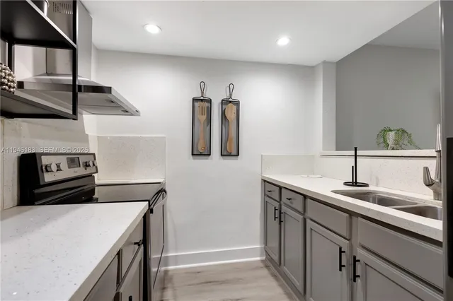 a kitchen with a sink and a refrigerator