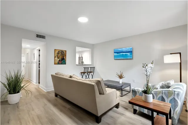 a living room with furniture and a potted plant