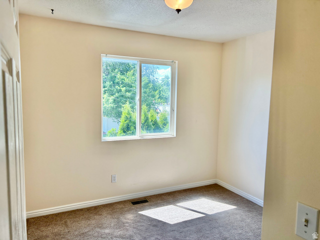 334 West Rodeo Lane South Logan, UT 84321 - Photo 7 of 12 Neutral-toned interior with a window providing exterior greenery
