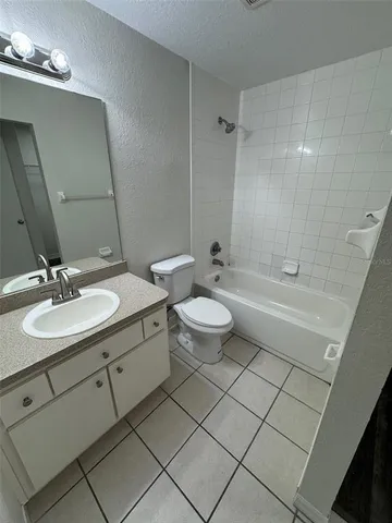 a bathroom with a double vanity sink mirror and toilet