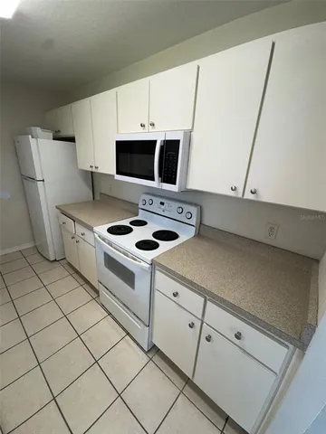 a kitchen with appliances cabinets and a sink