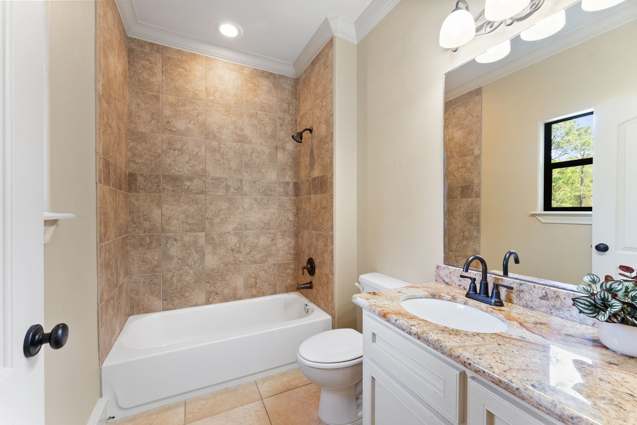 3907 Rayford Road Spring, TX 77386 - Photo 25 of 38 The private bath offers a granite countertop vanity, tub/shower combo, crown molding, and a window that brings in great natural light.