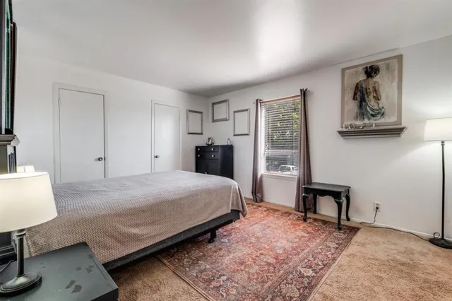 a bedroom with a bed and a lamp on table