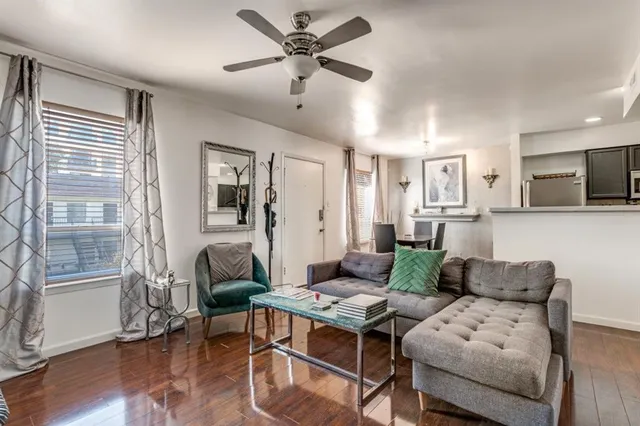 a living room with furniture and a wooden floor