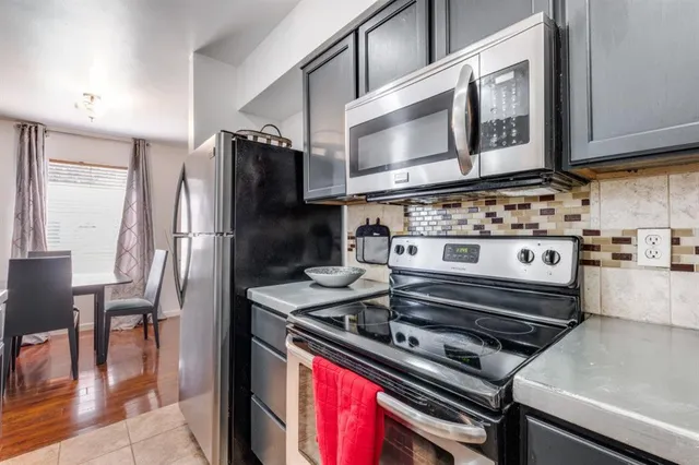 a kitchen with a stove microwave and cabinets
