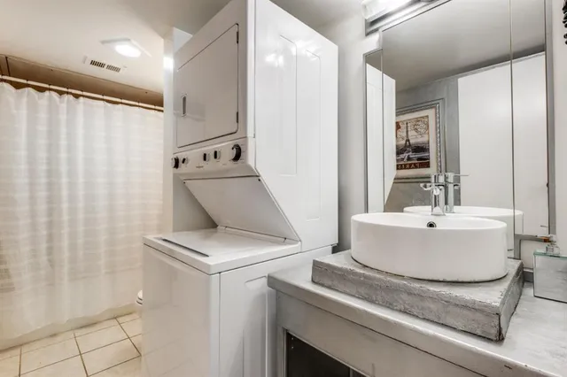 a white bath tub sitting next to a white sink and vanity