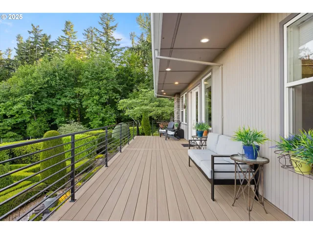 a balcony with chairs and wooden floor