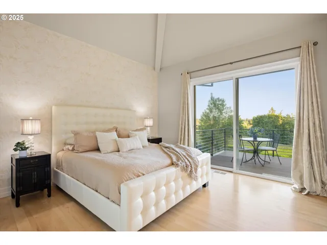 a bedroom with a large bed and a large window