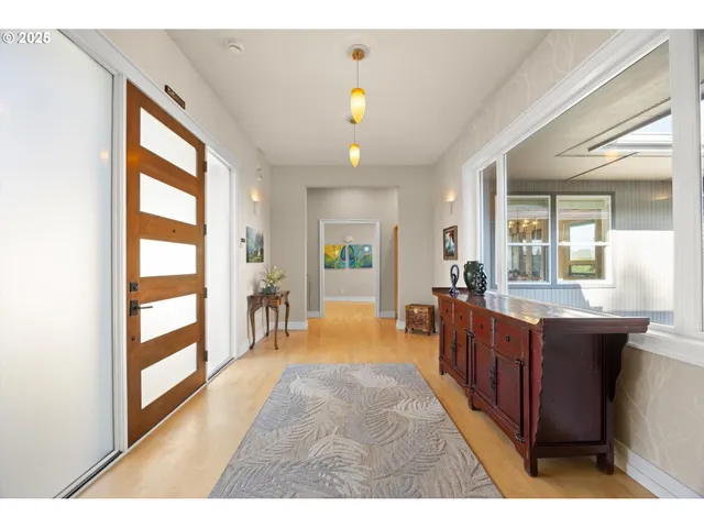 a living room with stainless steel appliances granite countertop furniture a fireplace and a large window