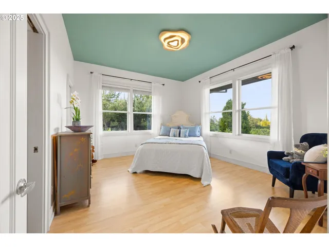 a bedroom with a bed and a large window