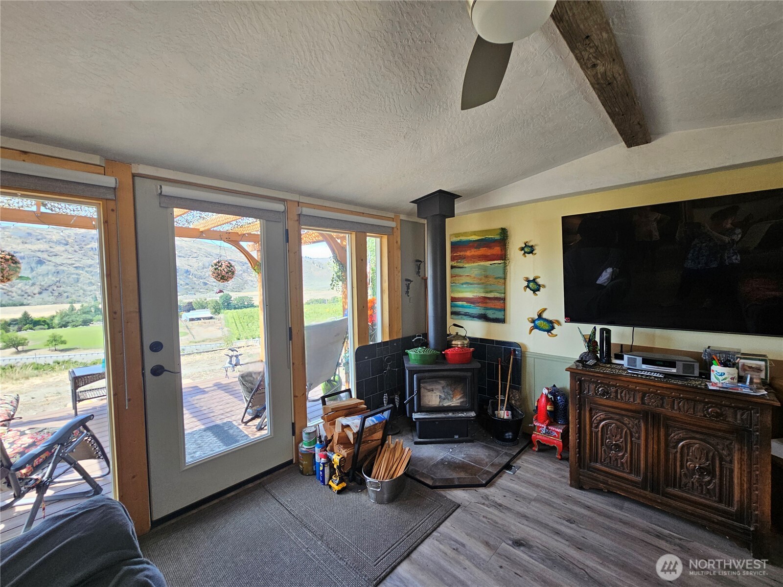 14 Bridgeview Road Tonasket, WA 98855 - Photo 11 of 32 a living room with furniture and a flat screen tv