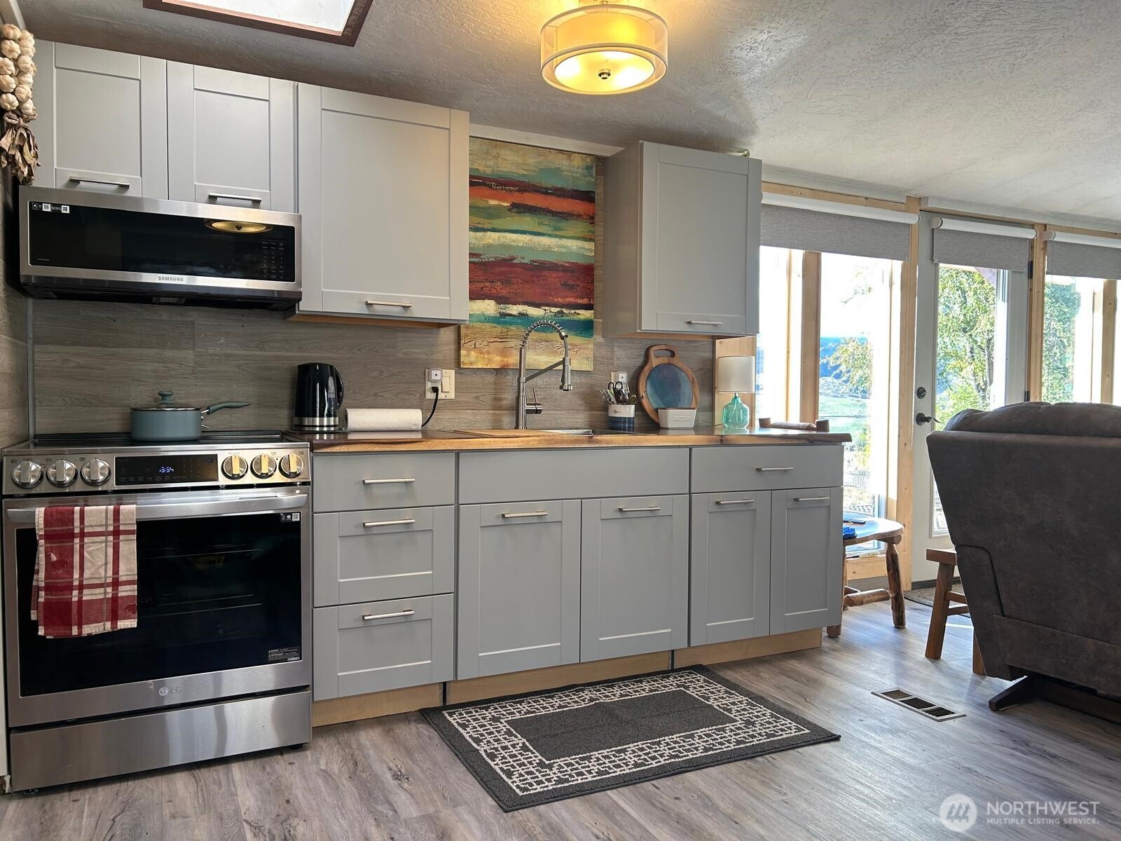 14 Bridgeview Road Tonasket, WA 98855 - Photo 15 of 32 a kitchen with stainless steel appliances a stove a sink cabinets and a window