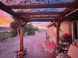 a view of a yard with wooden fence