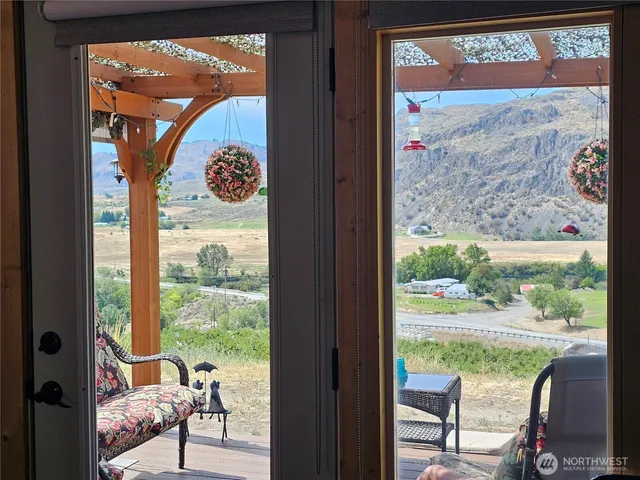 a view of living room filled with furniture and a floor to ceiling window