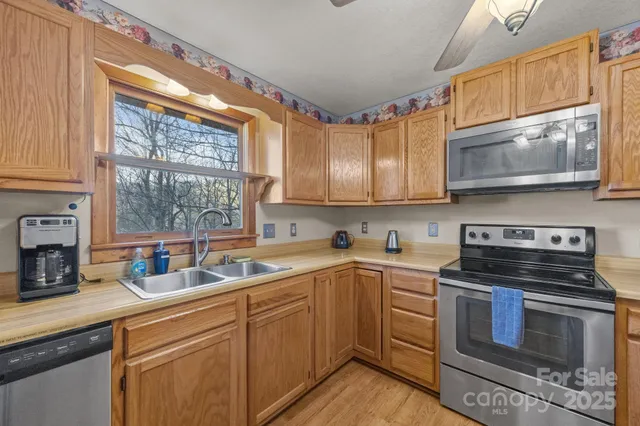 a kitchen with a sink stove top oven and cabinets