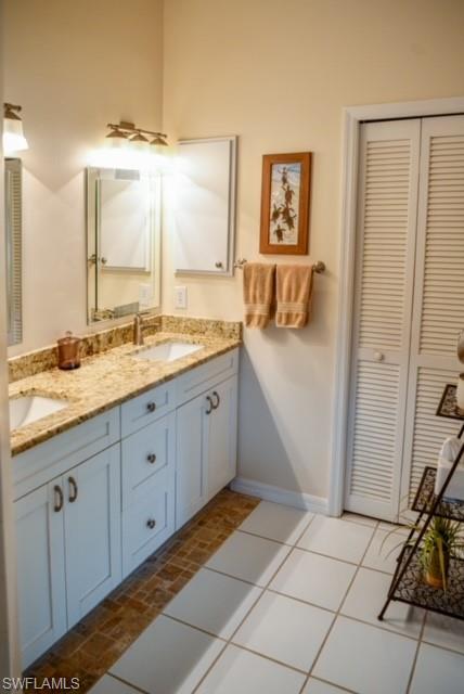 8083 Panther Trail, Unit 1504 Naples, FL 34113 - Photo 14 of 24 a spacious bathroom with a granite countertop sink a mirror and a bathtub