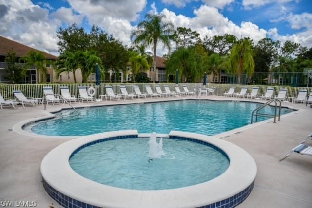 8083 Panther Trail, Unit 1504 Naples, FL 34113 - Photo 19 of 24 a view of a swimming pool with a patio