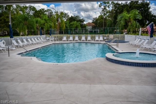 8083 Panther Trail, Unit 1504 Naples, FL 34113 - Photo 20 of 24 a view of a swimming pool with a patio