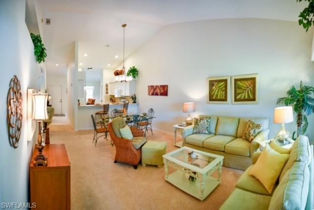 8083 Panther Trail, Unit 1504 Naples, FL 34113 - Photo 2 of 24 a living room with furniture and a chandelier