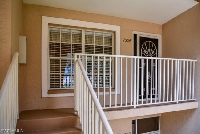 8083 Panther Trail, Unit 1504 Naples, FL 34113 - Photo 23 of 24 a view of a balcony with wooden floor