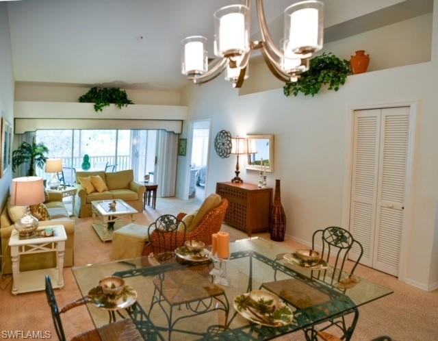 8083 Panther Trail, Unit 1504 Naples, FL 34113 - Photo 3 of 24 a living room with furniture chandelier and a window