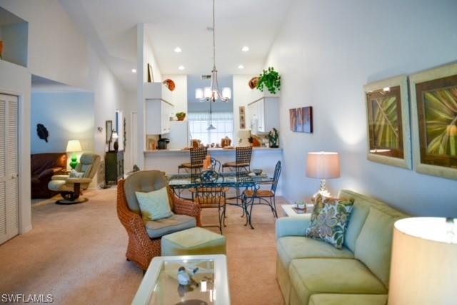 8083 Panther Trail, Unit 1504 Naples, FL 34113 - Photo 4 of 24 a living room with furniture and a large window