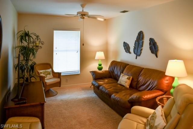 8083 Panther Trail, Unit 1504 Naples, FL 34113 - Photo 7 of 24 a living room with furniture a couch and a window
