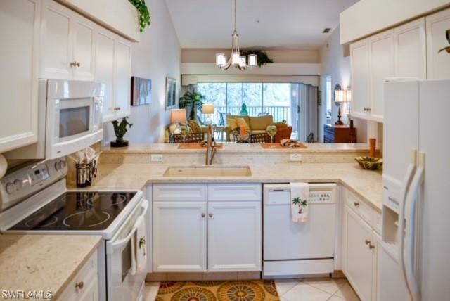 8083 Panther Trail, Unit 1504 Naples, FL 34113 - Photo 9 of 24 a kitchen with a sink stove and refrigerator